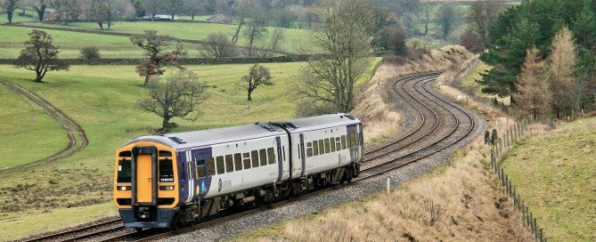 Class 158 train travels through the picturesque countryside